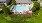 a swimming pool in a courtyard with lounge chairs